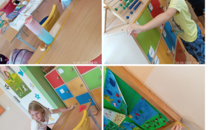 Uczniowie mierzą w klasie ławki, półki i tablicę korkową